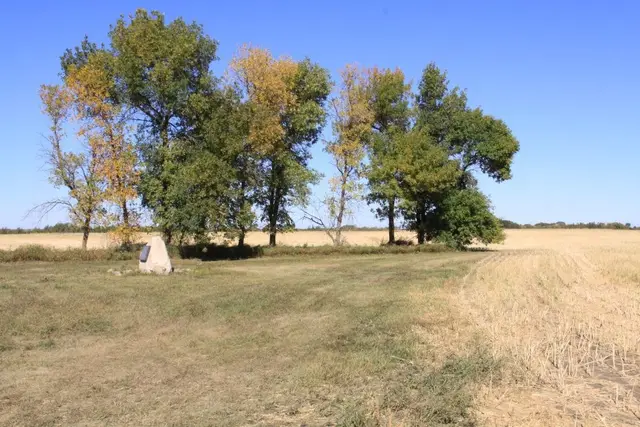 Schoolhouse site memorial stone in a field