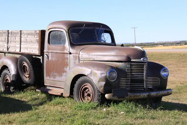 Old rusty farm truck in a field